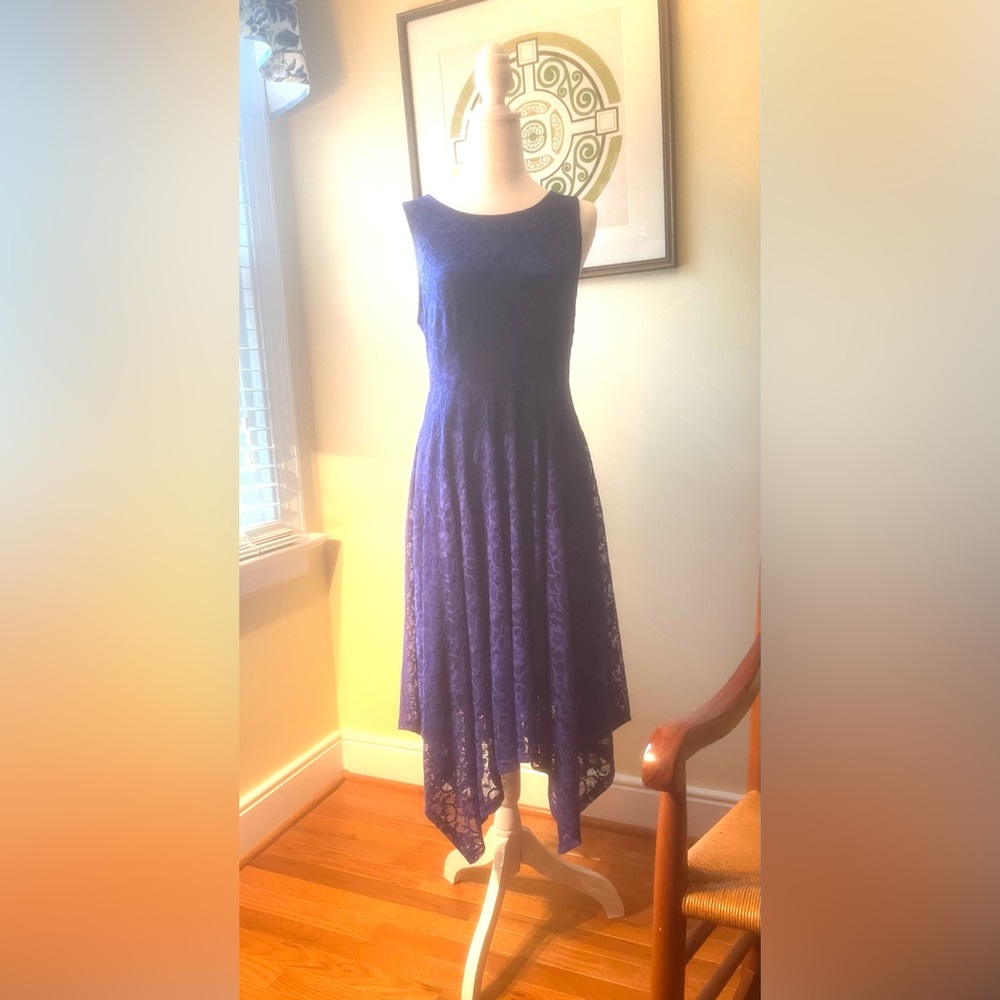 Beautiful sleeveless, lace, handkerchief hem dress.